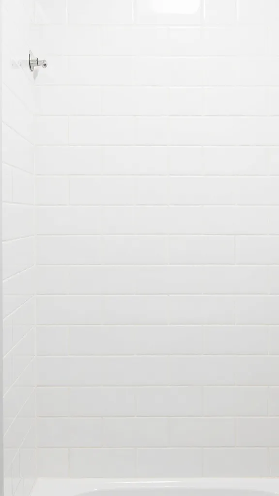 closeup of floor-to-ceiling white subway tile shower wall
