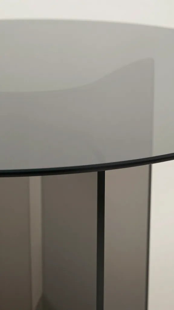 Smoky glass oval dining table, closeup of beveled edge
